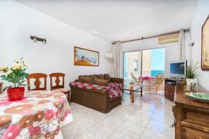 a living room with a couch and a television at Espanhouse Maestro sea view apartment in Torrevieja