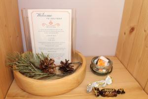 a box with a menu and a bowl with plants at Soltorp Eco Lodge in Porvoo