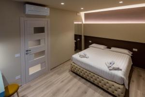 Postel nebo postele na pokoji v ubytování DiVino Rooms Deluxe