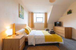 a bedroom with a bed and a television in it at Lower Clarence Road in Norwich