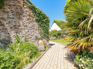 a brick walkway in front of a stone wall at Abalone in Bude