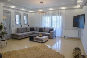 a living room with a couch and a table at Atlas Villa in Kremasti