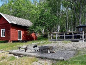 stolik piknikowy przed czerwoną stodołą w obiekcie 16 person holiday home in P LSBODA w mieście Hjortkvarn