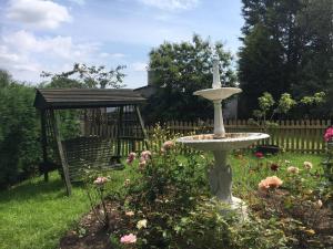 a bird bath in the middle of a garden at The Jewel in the Crown, countryside escape in Rushton Spencer