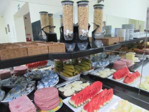 a buffet filled with lots of different types of food at Hotel Monteneve in São Paulo