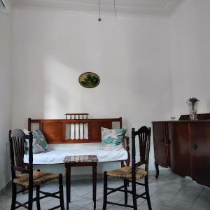 a room with a table and two chairs and a table with a couch at Maroudas Traditional Guest House in Vathi