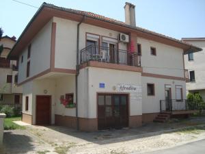 a white building with a balcony on top of it at Villa Afrodita in Ohrid