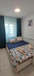 a bedroom with two twin beds with blue curtains at Abel Luxury Home in Constanţa