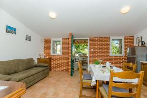 a living room with a couch and a table at House Tomislav in Kolan