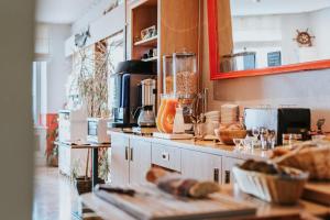 a kitchen with a counter with some food on it at Hôtel Aux Tamaris - Vue Mer in Roscoff