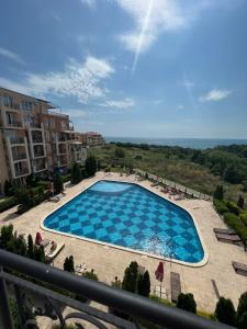 a view of a swimming pool from a balcony at Byala COZY APARTMENT in Byala
