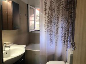 a bathroom with a sink and a shower curtain at Pearl kokkonaki in Kokóni +52 photos
