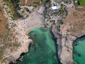 an aerial view of a beach with a pool of water at Le casette in Monopoli
