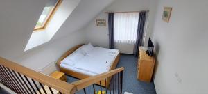 A bed or beds in a room at Hotel Vltava