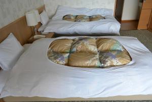 Cama ou camas em um quarto em Toya Kanko Hotel