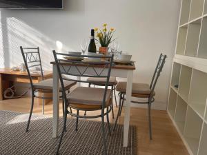 a dining room table and chairs with wine glasses on it at Holiday Home Fulham in London