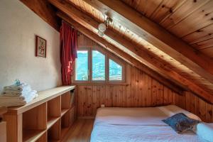 a bedroom with a bed in a wooden house at Baita dal Gat by Quokka 360 - Stylish Wooden Chalet Retreat in Faido in Sobrio