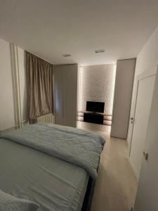 a bedroom with a bed and a window in it at New, modern apartment in Belgrade in Belgrade