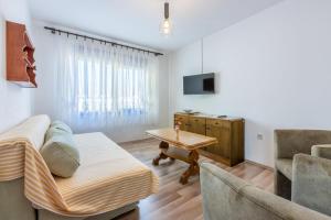 a living room with a couch and a table at Apartments Josip in Novi Vinodolski