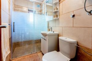 a bathroom with a toilet and a shower and a sink at Apartments Josip in Novi Vinodolski +29 photos