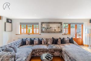 a large living room with a large couch at Dorney Barn, Close To Windsor Legoland in Dorney