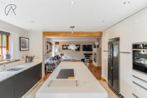 a kitchen and living room with a large counter top at Dorney Barn, Close To Windsor Legoland in Dorney