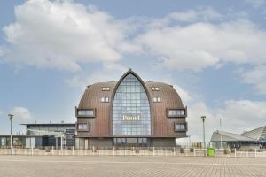 a round building with a window on the side of it at Poort Beach Boutique Apartments in Bloemendaal Aan Zee
