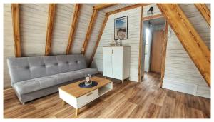 a living room with a couch and a table at ALOHA Rowy in Rowy