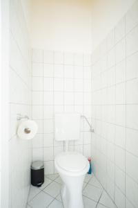 a white bathroom with a toilet and a sink at Lovely 2-bedroom apartment next to Praterstern in Vienna