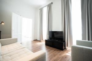 a living room with a couch and a television at Lovely 2-bedroom apartment next to Praterstern in Vienna