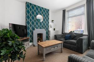 a living room with a couch and a fireplace at Spacious & Unique Family and Contractor House & Parking & A1 Road in Grantham