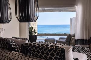 a living room with a couch and a view of the ocean at Artemis Seaside Resort in Paliochori