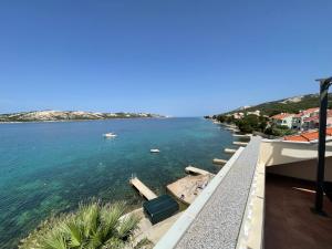 a view of the ocean from the balcony of a house at Apartments Andrea in Stara Novalja