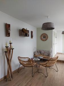 a living room with a table and chairs and a couch at Une affaire de famille in Le Portel