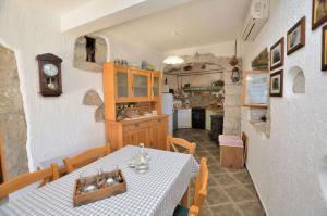 a kitchen and dining room with a table and chairs at House Mikleus in Lovran