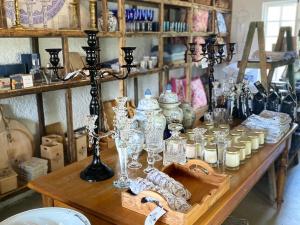 a table with glasses and other items on it at Weltevrede Fig Farm in Prince Albert