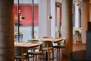 a row of tables and chairs in a restaurant at Aloft London Excel in London