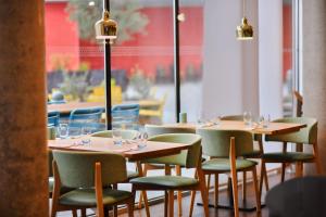 a row of tables and chairs in a restaurant at Aloft London Excel in London