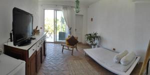 a living room with a flat screen tv and a couch at Casa Carmela in Ponza