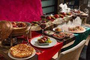 a table topped with lots of food and glasses of wine at AQI Hydros Club in Kemer