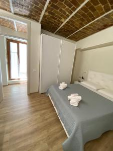 a bedroom with a bed with towels on it at La cattedrale del mare in Termoli
