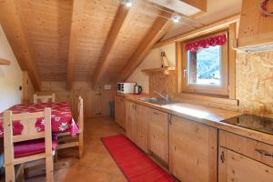 a kitchen with a sink and a table in a cabin at La Baitina app C in Livigno