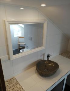 a bathroom with a sink and a mirror at Apartments Kuća Nebeska in Viganj