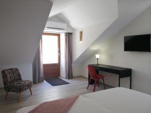 a room with a bed and a desk and a chair at Apartments Kuća Nebeska in Viganj