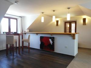a living room with a table and a fireplace at Apartments Kuća Nebeska in Viganj