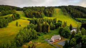 an aerial view of a house on a hill with trees at Vila Rasola in Malá Morávka