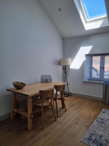 a dining room with a table and chairs and a window at 19a Brooks Road in Street
