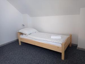 a small bed in a corner of a room at Słoneczny Domek in Grywałd +43 photos