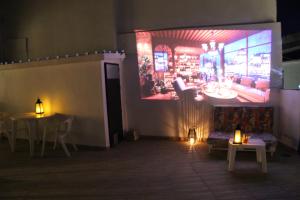 a living room with a couch and a large screen at Spa, Sierra y sol in Cortes de la Frontera