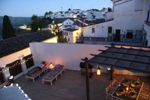 a woman sitting on the balcony of a building at Spa, Sierra y sol in Cortes de la Frontera